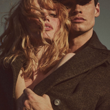 Two people embracing with a neutral background and 'AUTER' branding.