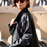 lily collins wears auter leather drawstring jacket
